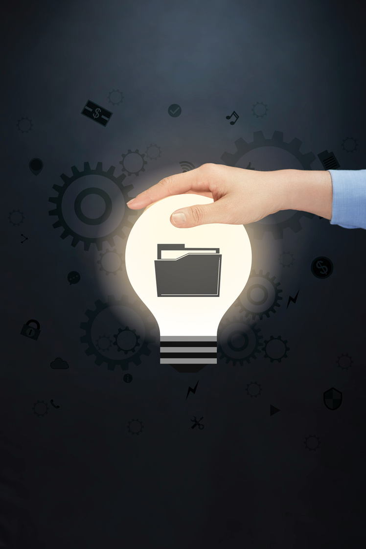 Hand presenting business folder icon on light bulb concept